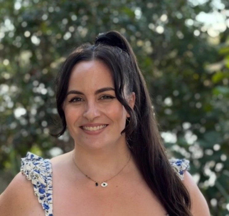 Emily, founder of Be Heard Health, smiling outdoors